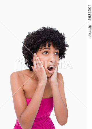 Surprised teenage girl looking to the side while putting her han Surprised teenage girl looking to the side while putting her han 6628004