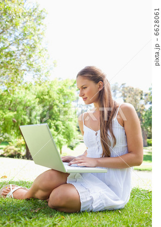Woman on the lawn with her laptop 6628061