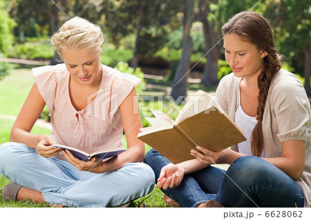 Friends reading books in the park Friends reading books in the park 6628062