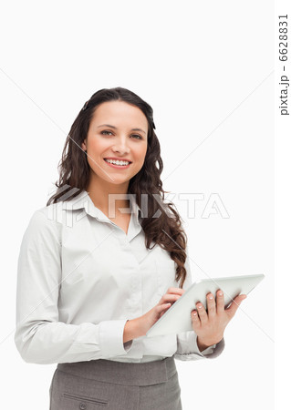 Portrait of a brunette standing while using a touchpad 6628831
