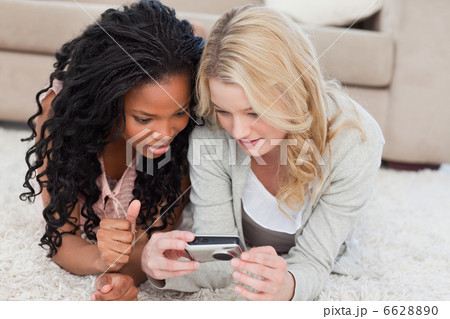 A woman holding a digital camera is looking a photos on a digita A woman holding a digital camera is looking a photos on a digita 6628890