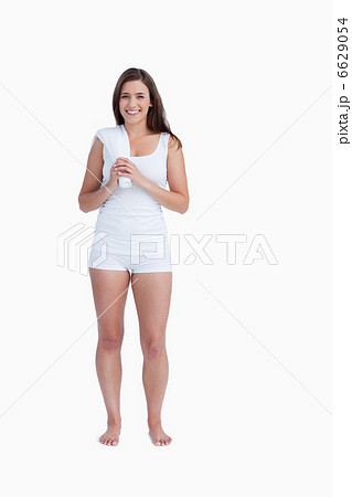 Young smiling brunette holding a towel 6629054