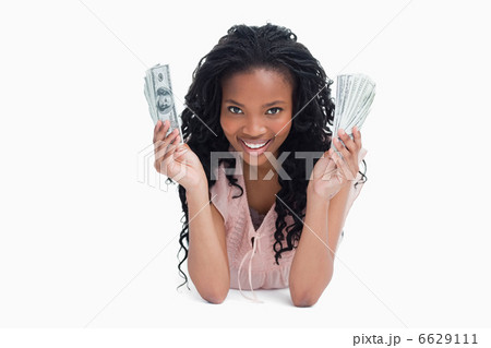 A young woman is holding American dollars and smiling at the cam A young woman is holding American dollars and smiling at the cam 6629111