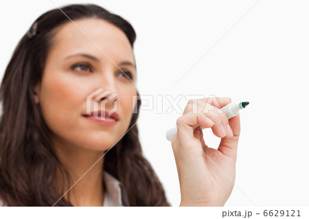 Close-up of a brunette writing with a whiteboard marker 6629121