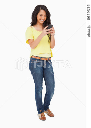 Beautiful Latin laughing while using a smartphone Beautiful Latin laughing while using a smartphone 6629336