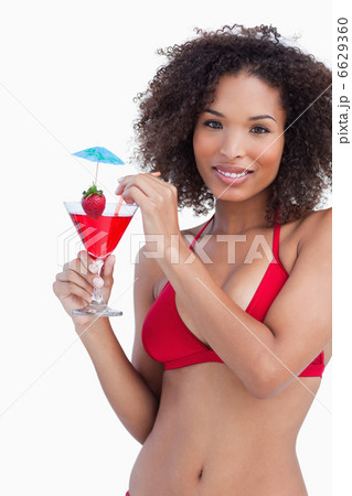 Attractive brunette woman looking at the camera while holding a 6629360