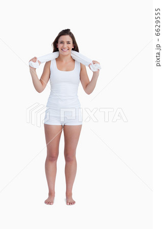 Smiling young woman looking at the camera while holding a towel 6629555