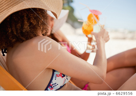 Side view of young women clinking their glasses 6629556