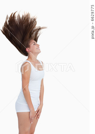Smiling brunette flipping her hair 6629775