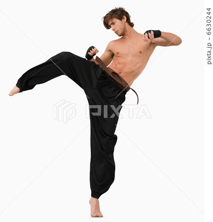 Side view of kicking martial arts fighter Side view of kicking martial arts fighter 6630244