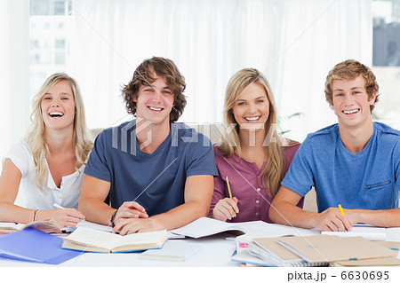 Four smiling students looking into the camera Four smiling students looking into the camera 6630695