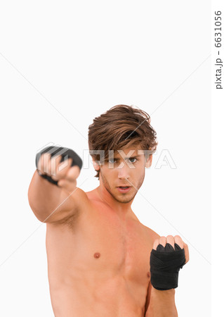Martial arts fighter in offensive pose 6631056