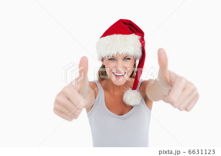 Woman with the thumbs up and a Christmas hat Woman with the thumbs up and a Christmas hat 6631123