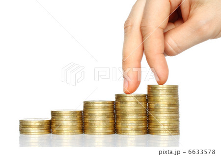 Fingers walking down on stacks of coins . Fingers walking down on stacks of coins . 6633578