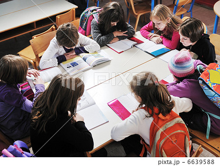 happy kids with teacher in school classroom happy kids with teacher in school classroom 6639588