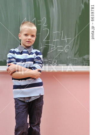 happy young boy at first grade math classes 6639781