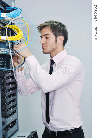 young it engineer in datacenter server room young it engineer in datacenter server room 6640802