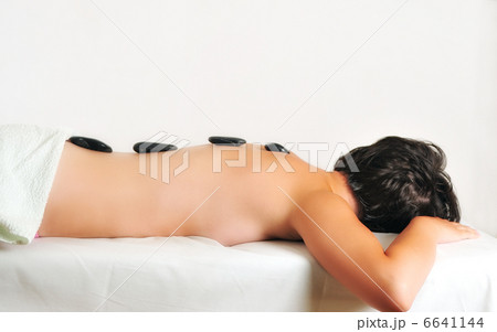 beautiful woman have hotstone massage at spa and wellness center 6641144