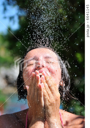 young pretty woman relaxing under shower 6641145