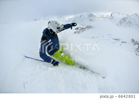 skiing on fresh snow at winter season at beautiful sunny day 6642801