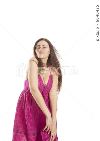 Pretty young girl in red dress posing in studio 6646435