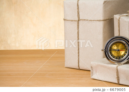 parcel wrapped and compass on wood 6679005