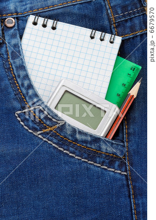 notebook and pencil on jeans 6679570