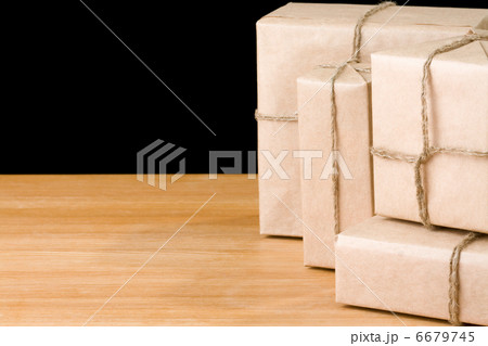parcel wrapped packaged box isolated on black parcel wrapped packaged box isolated on black 6679745