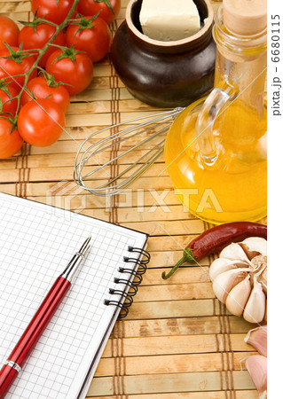 oil, garlic and tomato with pen on notebook 6680115