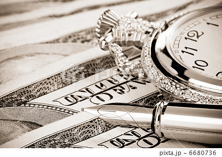 ink pen and watch on dollar banknotes 6680736
