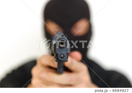 銃を持った覆面の男の写真素材