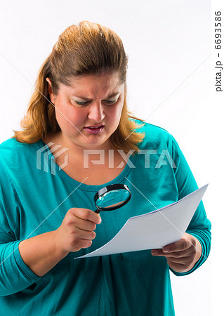 Woman looking through magnifying glass or loupe 6693586