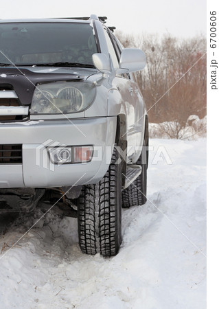 Snowy winter road ahead an unrecognizable car Snowy winter road ahead an unrecognizable car 6700606
