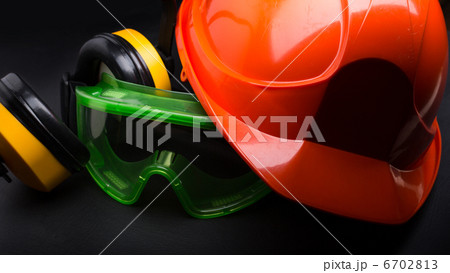 Red safety helmet with earphones and goggles Red safety helmet with earphones and goggles 6702813