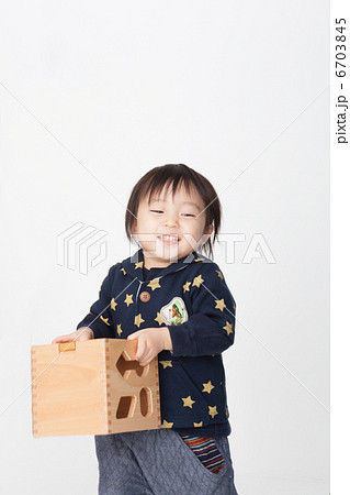 おもちゃを抱える子供の写真素材