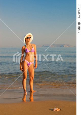 Beautiful blond girl relaxing on the beach 6704711