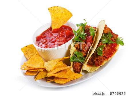 plate with taco, tortilla chips and tomato dip 6706926