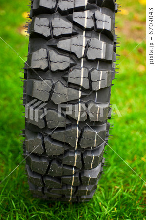 Tire at green grass 6709043