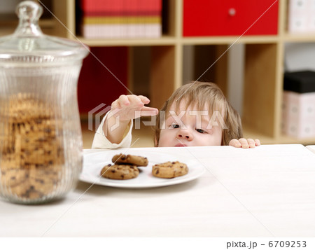 Little boy stealing cookies 6709253