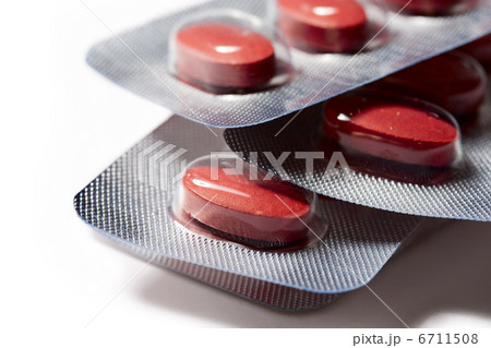 Red pills in plastic pack on the white background 6711508