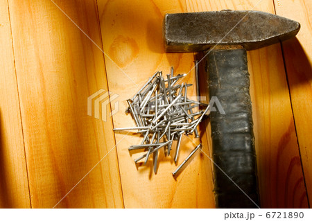 Hammer and nails isolated on the wooden background 6721890