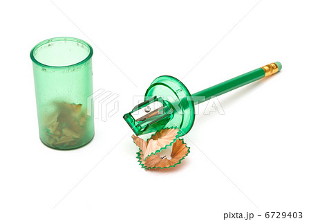 Green sharpener and pencil on white background. 6729403