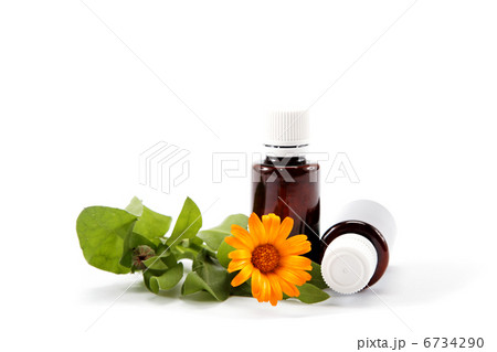 Medications and marigold flower isolated on white background. Medications and marigold flower isolated on white background. 6734290