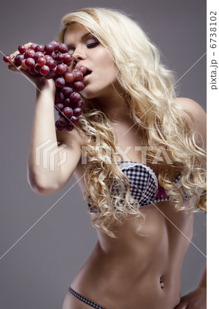 young beautiful blonde posing with grape, studio shot 6738102