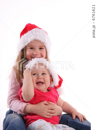 Brother with sister in Christmas hats 6761621