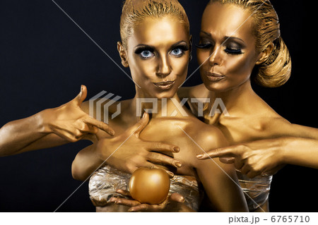 Masquerade. Enjoyment. Two Glossy Women with Golden Body Art. Glamor Masquerade. Enjoyment. Two Glossy Women with Golden Body Art. Glamor 6765710