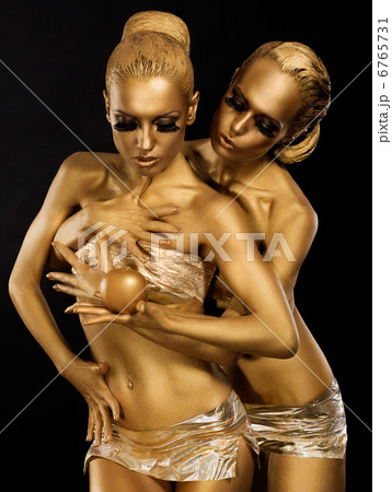 Glitter. Glaze. Seductive Women with Golden Bodies Hugging. Fantasy 6765731