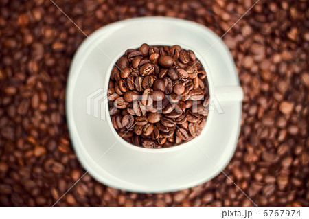 White cup filled with coffee beans White cup filled with coffee beans 6767974