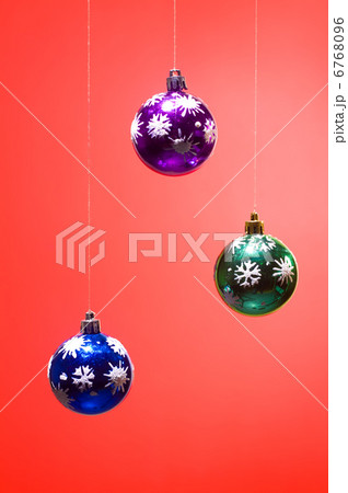 three xmas balls on red background vertical 6768096