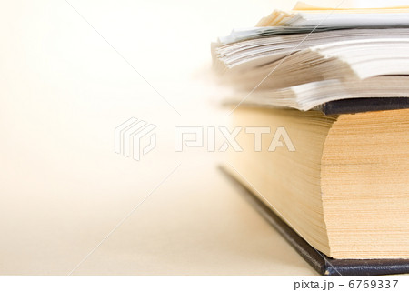 A pile of paper and a book A pile of paper and a book 6769337